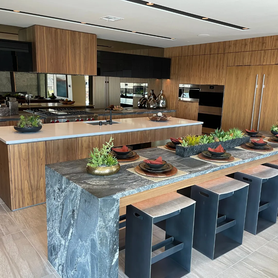 Kitchen island with a quartz countertop and a Dekton-surface dining table set with place settings